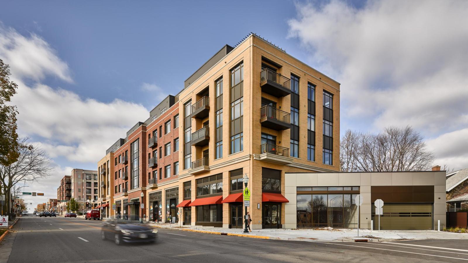 Modern exterior design with first floor retail and apartments above at 1700 Monroe 