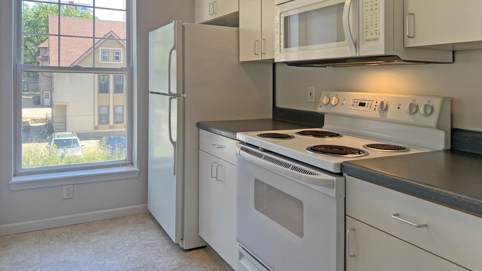 Kitchen with standard appliances and cabinetry at City Place Apartments
