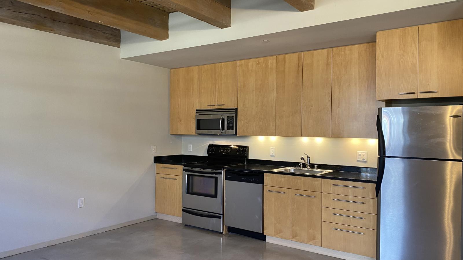 Spacious one bedroom with polished concrete floors, modern appliances, and historic charm at Tobacco Lofts
