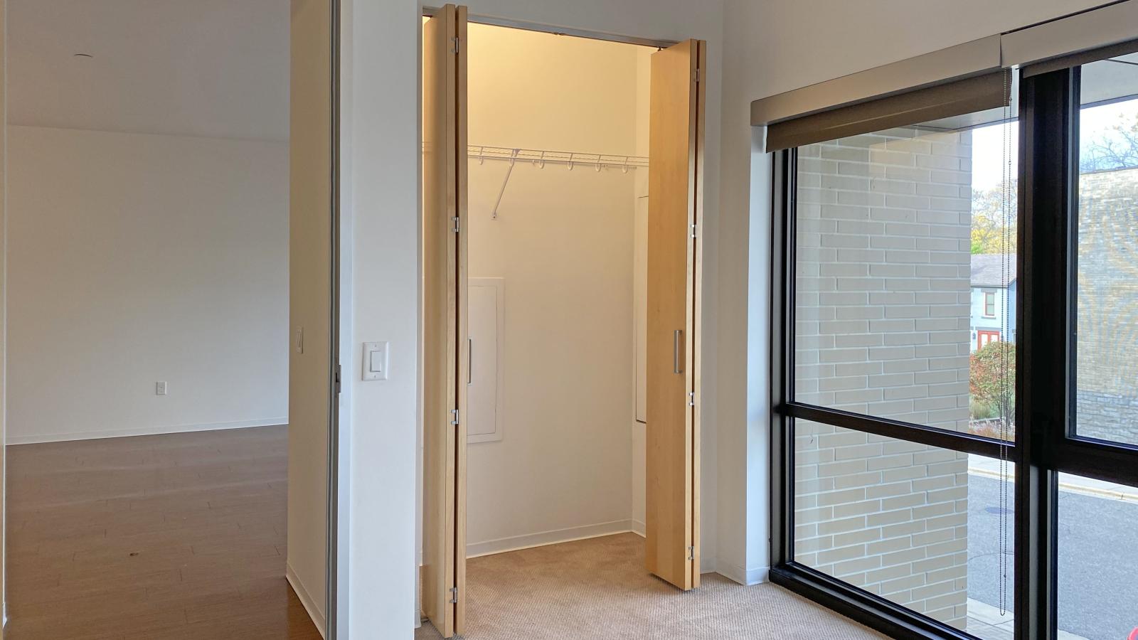 One bedroom with open layout and standard closet for ample storage at SEVEN27