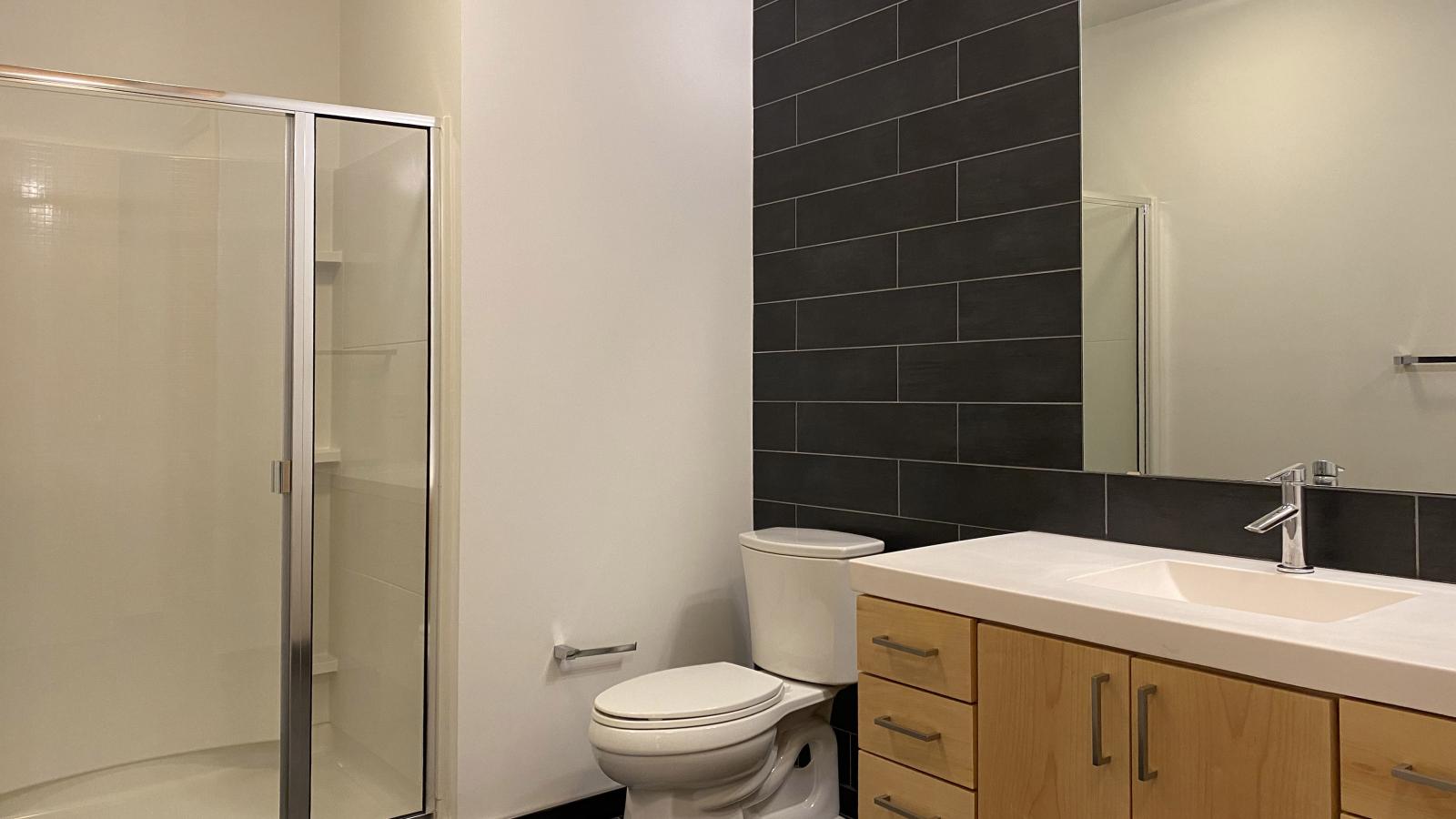 Contemporary bathroom with glass shower and modern tile at SEVEN27