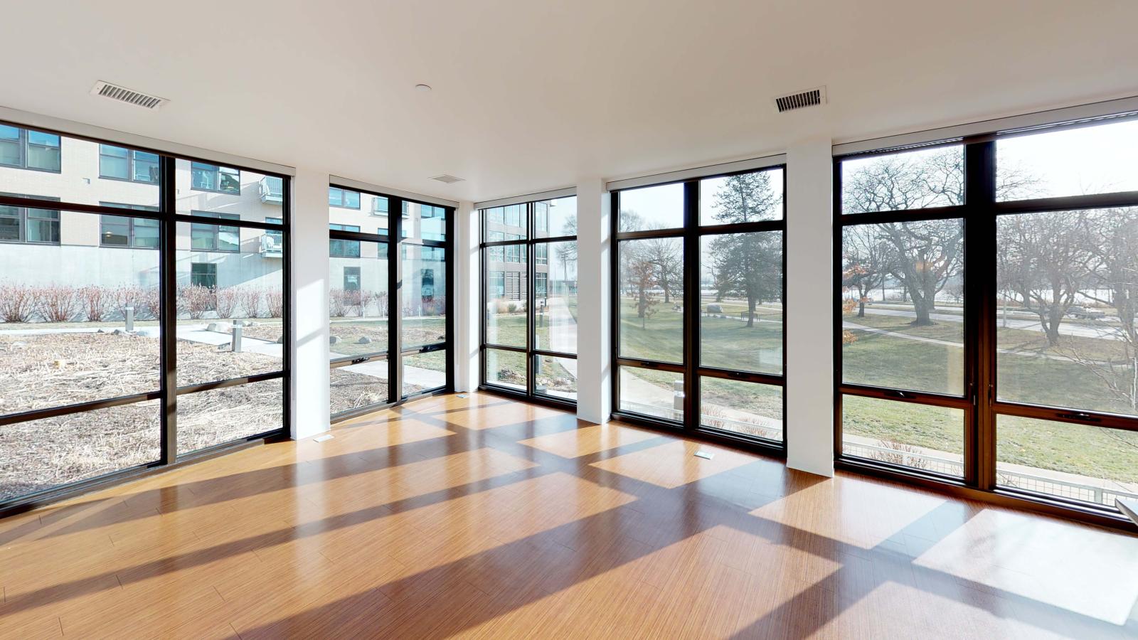 Spacious living room with large windows and stunning lake views at SEVEN27