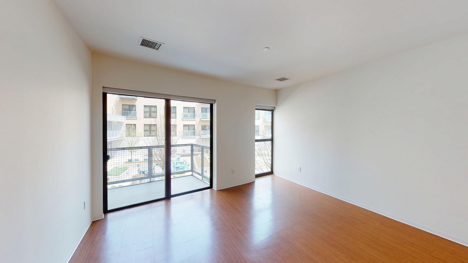 Open living space with natural light with large balcony overlooking the courtyard at SEVEN27 in downtown Madison