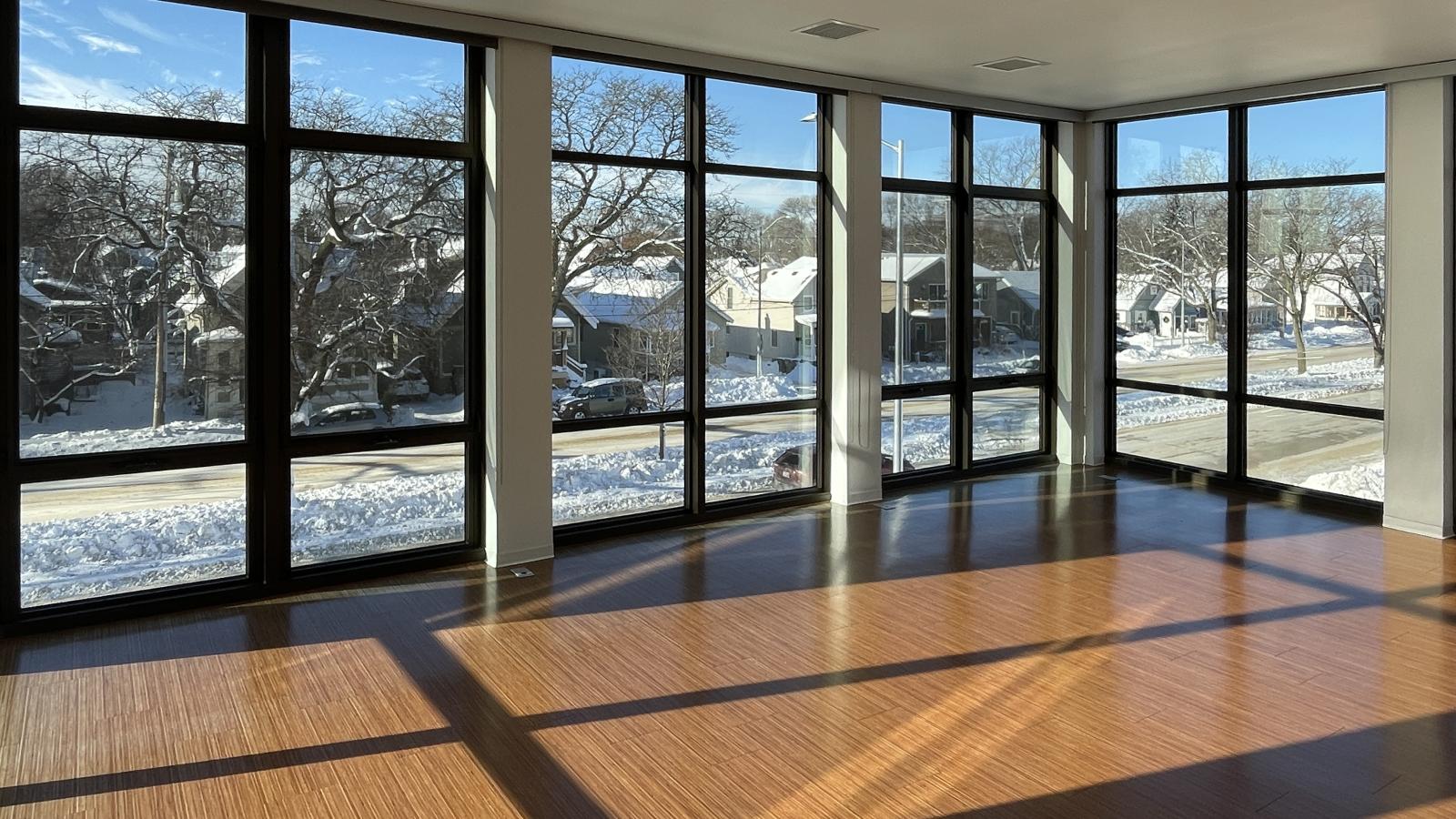 Spacious living room with floor to ceiling windows in a two bedroom apartment at SEVEN27 Apartments in downtown Madison