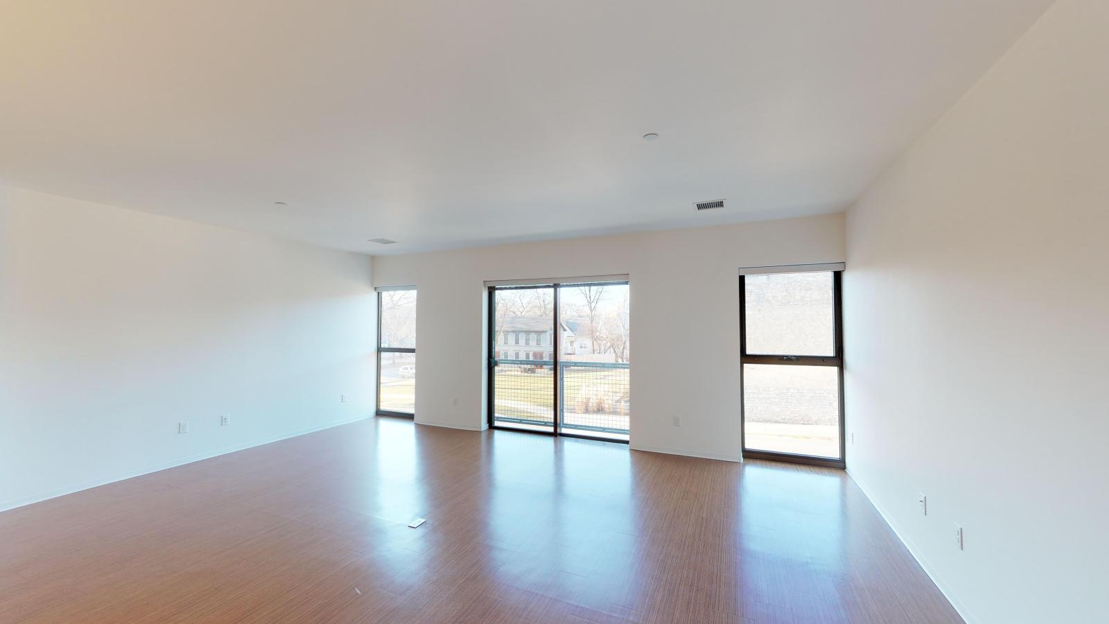 Spacious living room with large windows and abundant natural light at SEVEN27