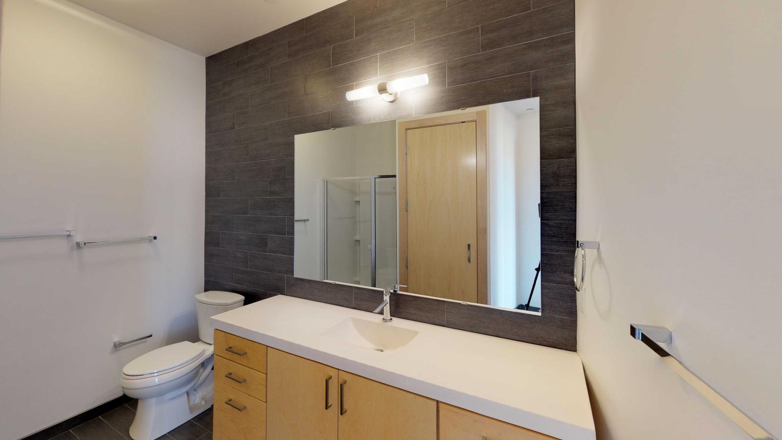 One bedroom apartment bathroom with spacious vanity and designer fixtures at SEVEN27