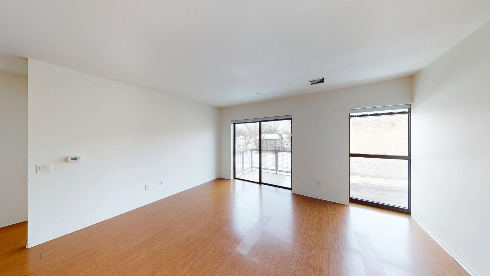 Open concept design with a larger than average living space, and a balcony, in a one bedroom at SEVEN27 in downtown Madison