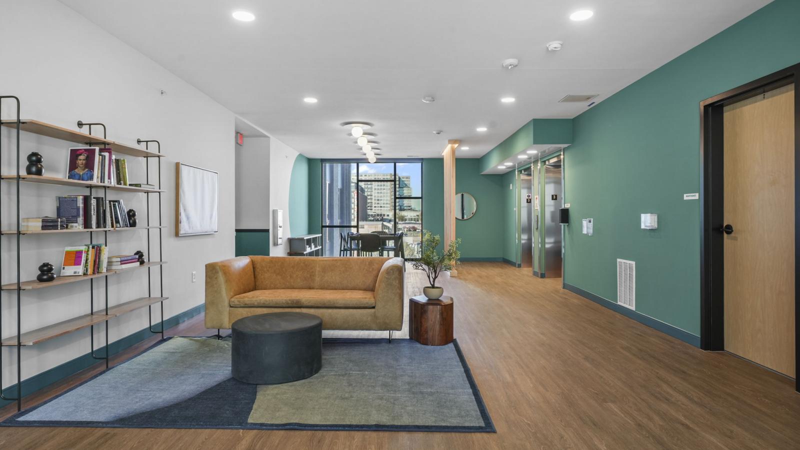 The Irwin den featuring comfortable seating and space for casual resident gatherings