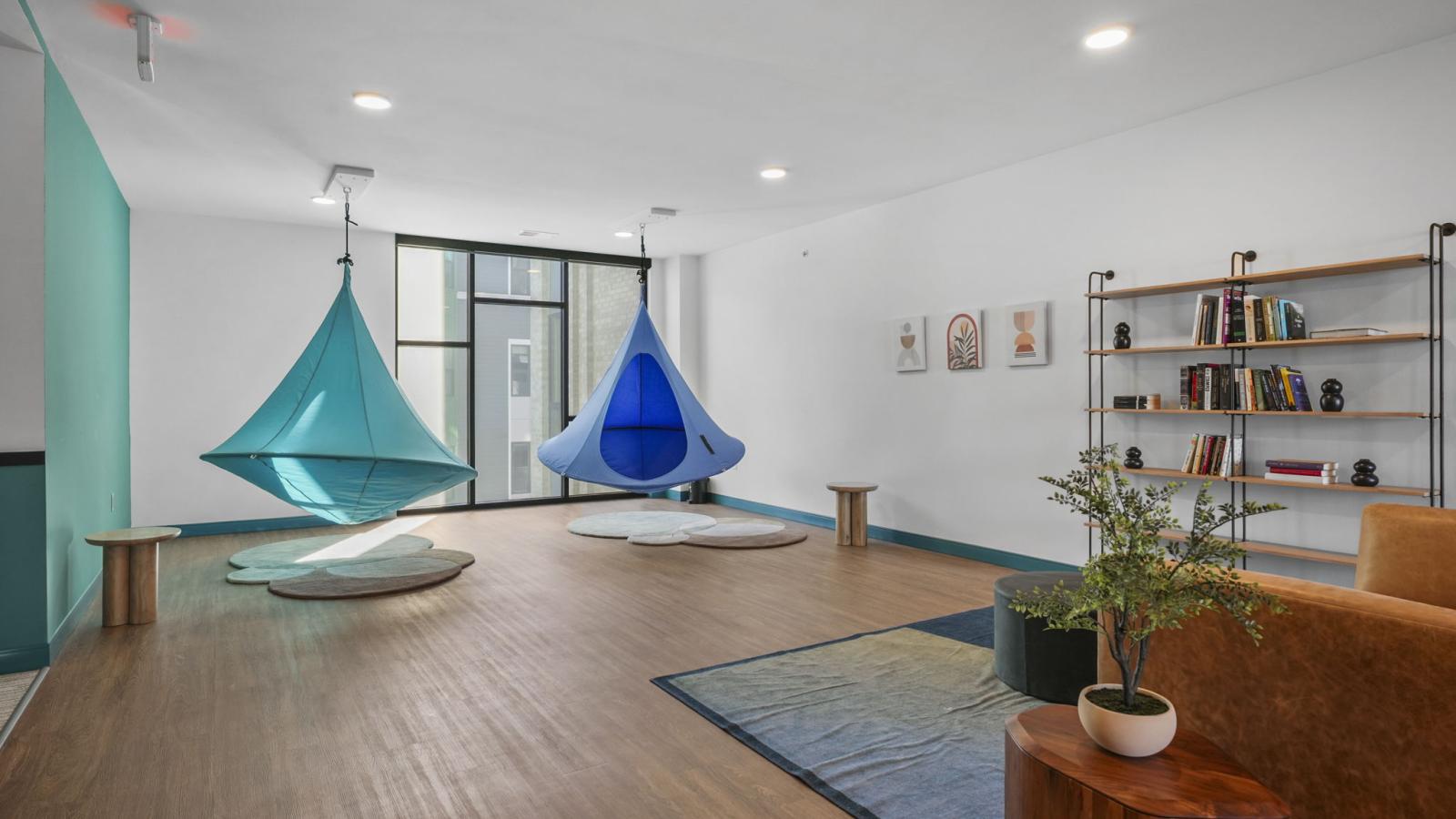 The Irwin den with lounge seating, game table, and relaxed space for residents to gather