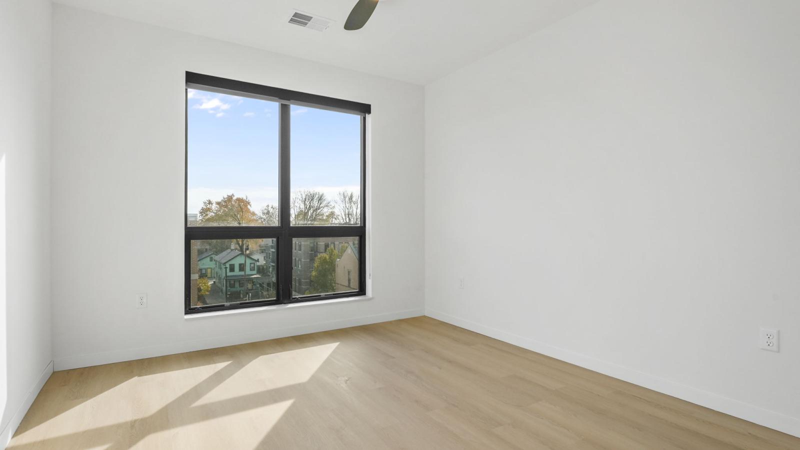 The Irwin apartment bedroom with stunning natural light, closet space, and clean finishes